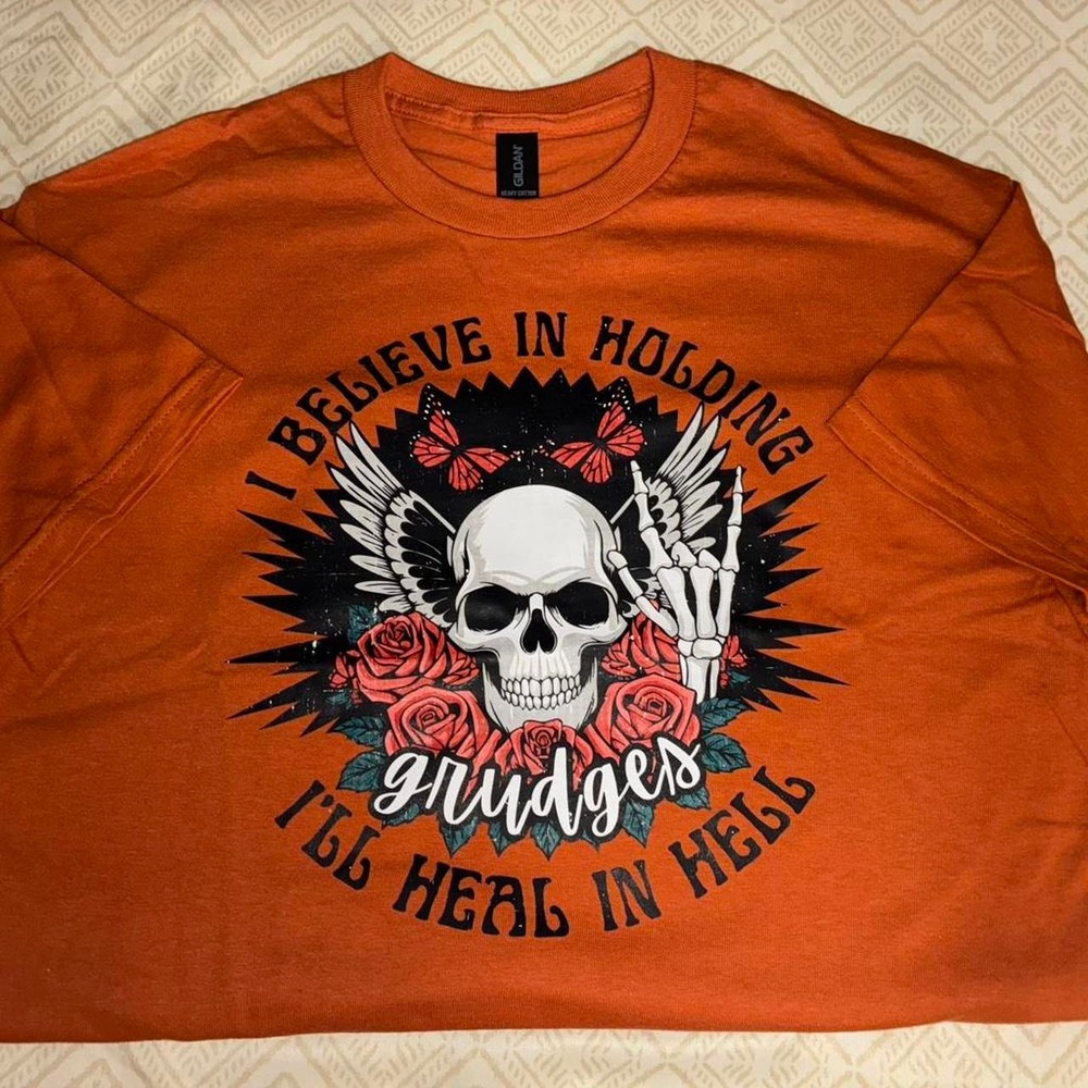 bold skull & roses design on a burnt orange .Brand new & freshly pressed